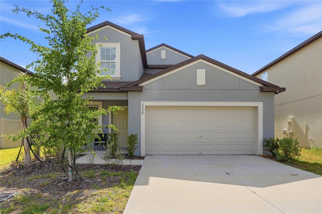 A two-story gray house with a two-car garage and a concrete driveway — 2256 TENEROC TRAIL, LAKELAND, FL