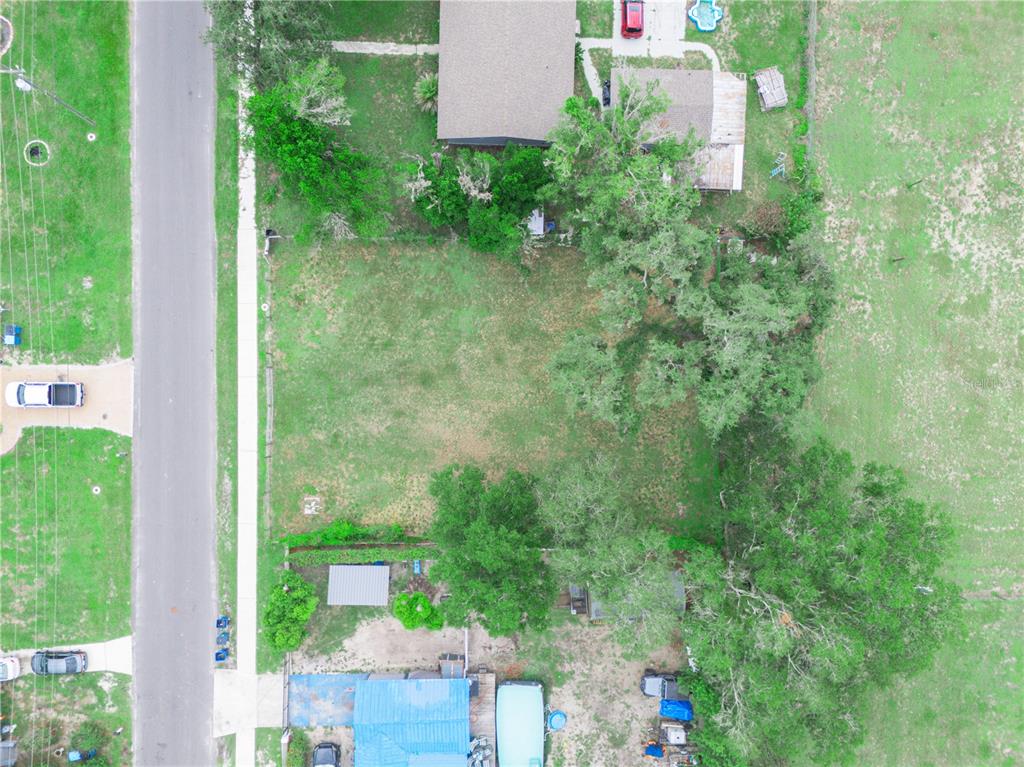 An aerial view shows a vacant rectangular residential lot situated between two existing properties — 314 SE 3RD STREET, FORT MEADE, FL
