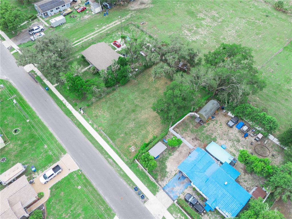 An aerial view shows two houses with large yards and driveways along a residential street — 314 SE 3RD STREET, FORT MEADE, FL