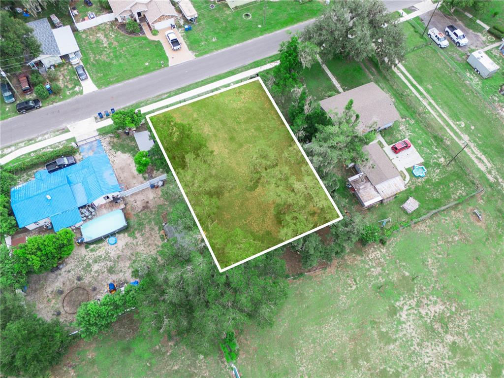 An aerial view shows a rectangular vacant lot highlighted in white between two residential properties — 314 SE 3RD STREET, FORT MEADE, FL