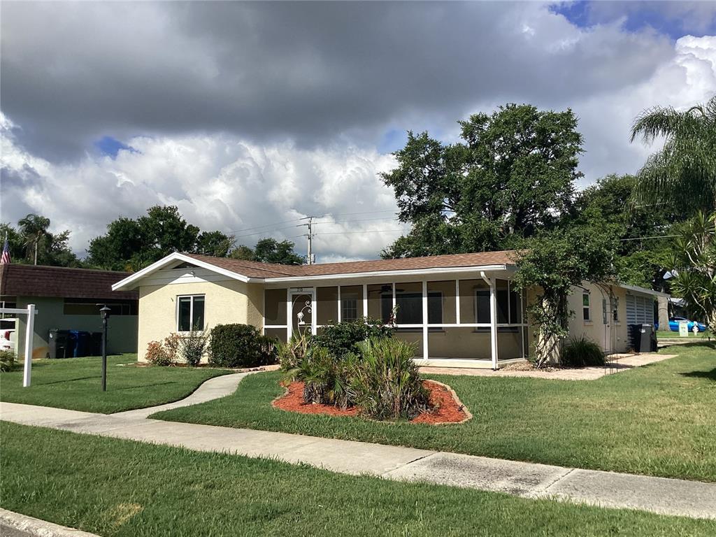 A single-story house with a screened-in front porch and a concrete walkway — 710 50TH STREET COURT W, BRADENTON, FL