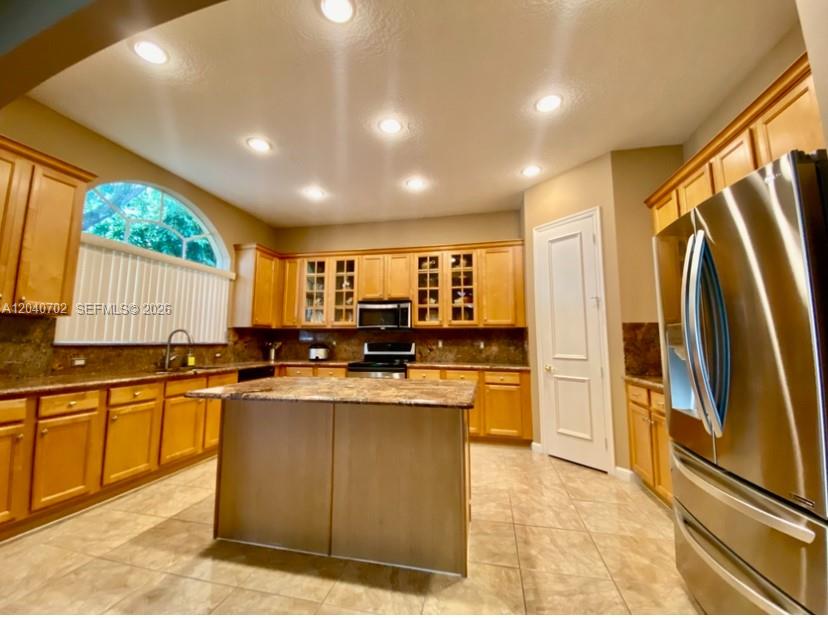 A kitchen with light wood cabinets, a central island, and stainless steel appliances — 13187 SW 26th St, Miramar FL 33027, MIRAMAR, FL