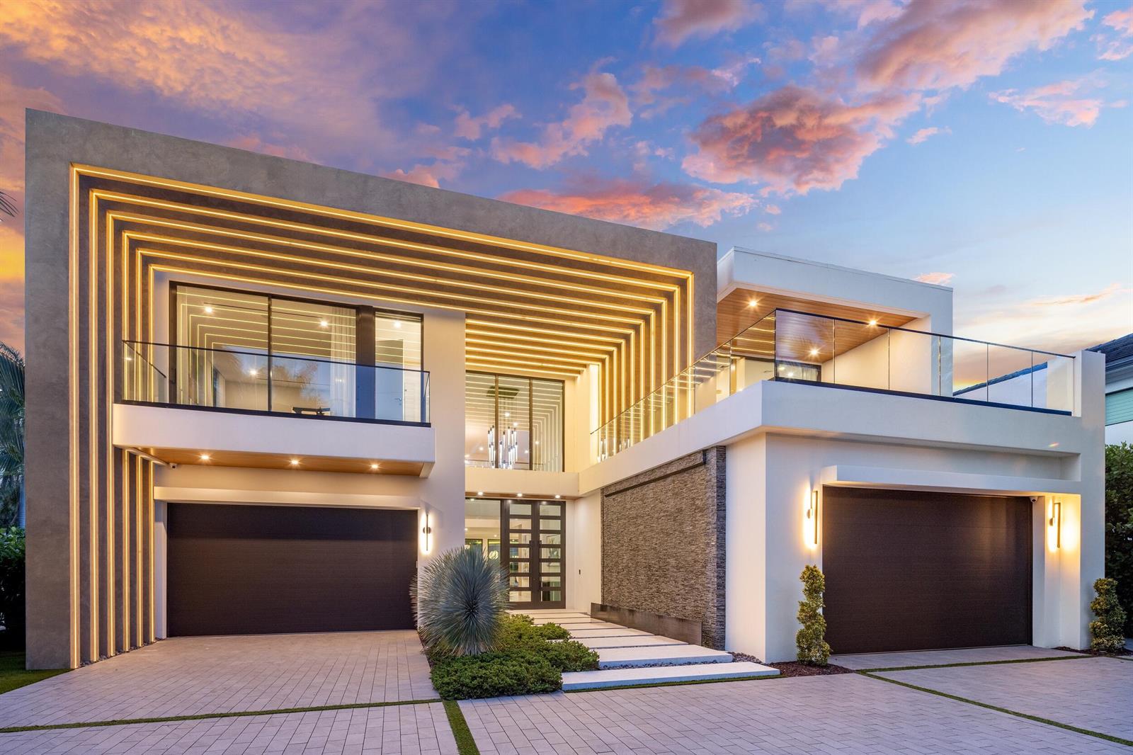 A modern two-story house with a stone accent wall, integrated LED lighting, and two garages — 217 Thatch Palm Drive, Boca Raton FL 33432, BOCA RATON, FL