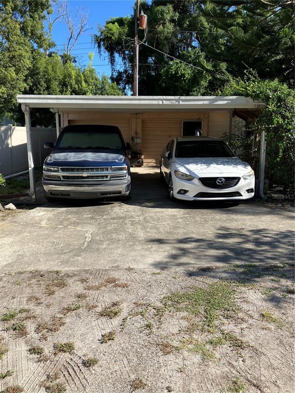 A dark green exterior door sits between a window and a painted mural wall — 17010 CRAWLEY ROAD, ODESSA, FL