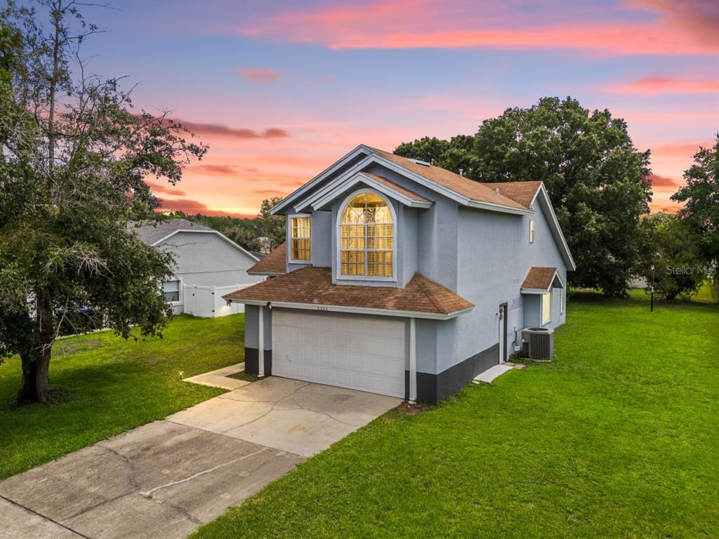 A two-story house with a gray stucco exterior, a two-car garage, and a brown roof — 2233 ARDON AVENUE, ORLANDO, FL