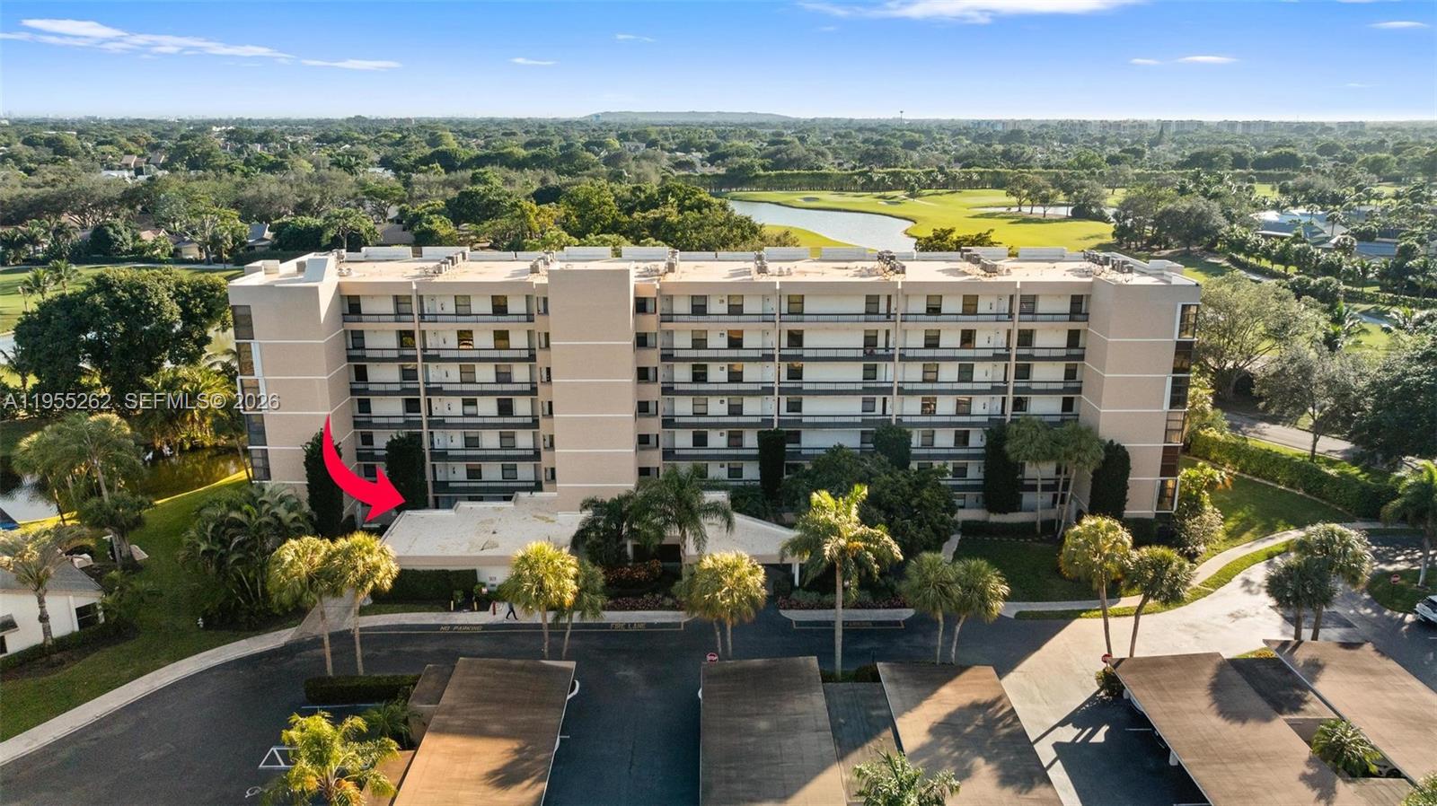 An aerial view shows a multi-story apartment building with a flat roof and parking structures — 6662 Boca Del Mar Dr # 112, Boca Raton FL 33433, BOCA RATON, FL
