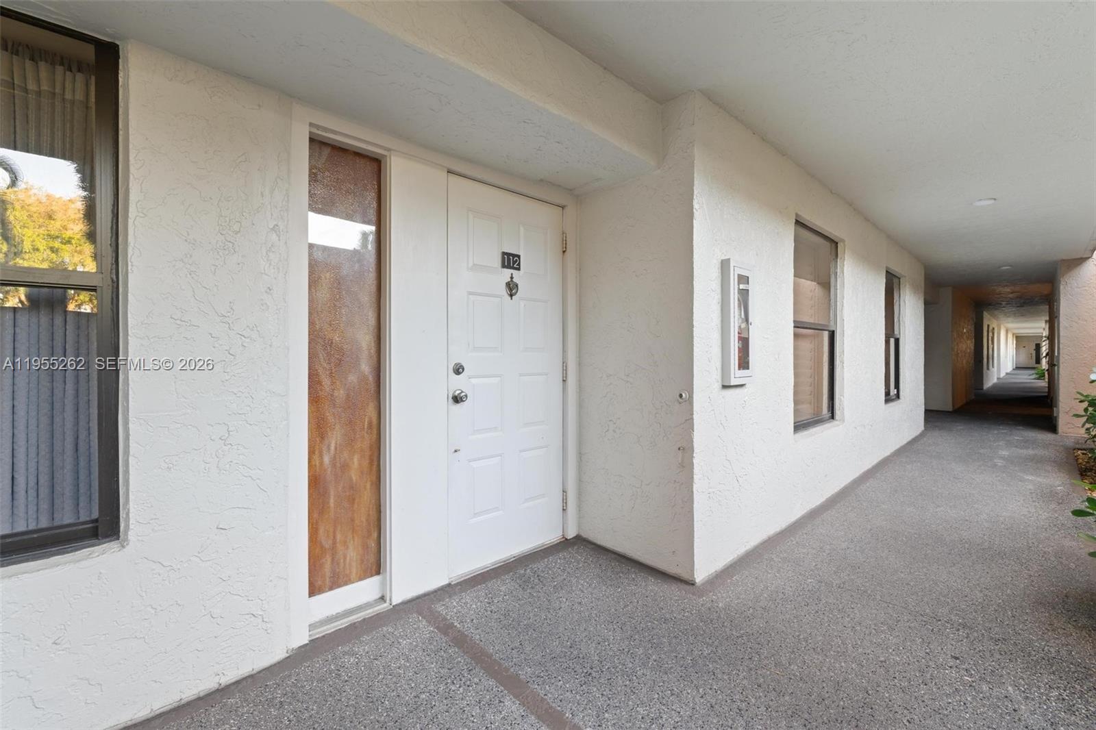 The exterior view shows a white front door labeled 112 along a covered walkway — 6662 Boca Del Mar Dr # 112, Boca Raton FL 33433, BOCA RATON, FL