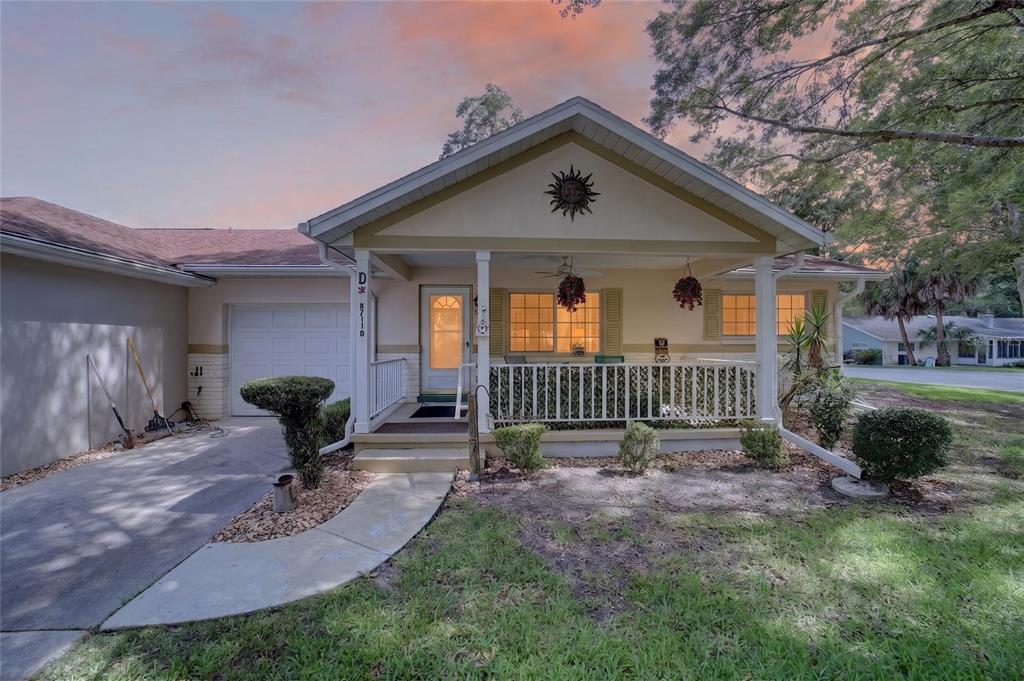 A single-story house with a front porch, white railings, and a concrete driveway — 8711 SW 96TH LANE UNIT D, OCALA, FL