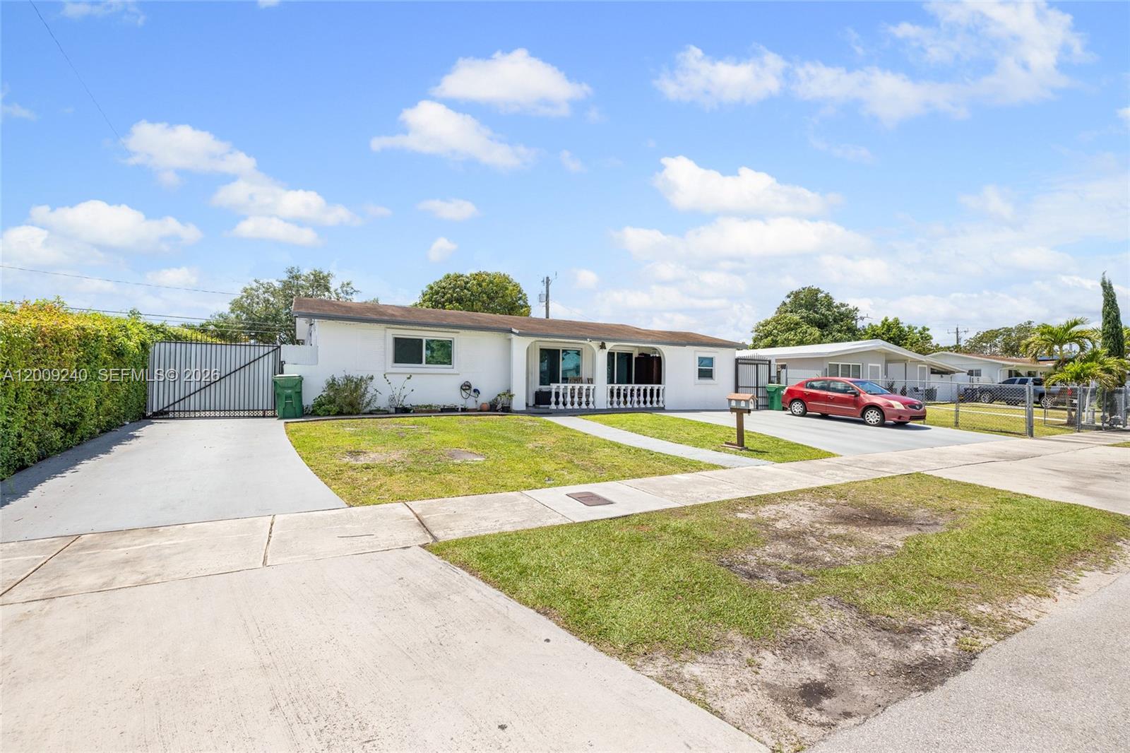 A single-story white house with a front porch and two concrete driveways — 11810 SW 172nd St, Miami FL 33177, MIAMI, FL