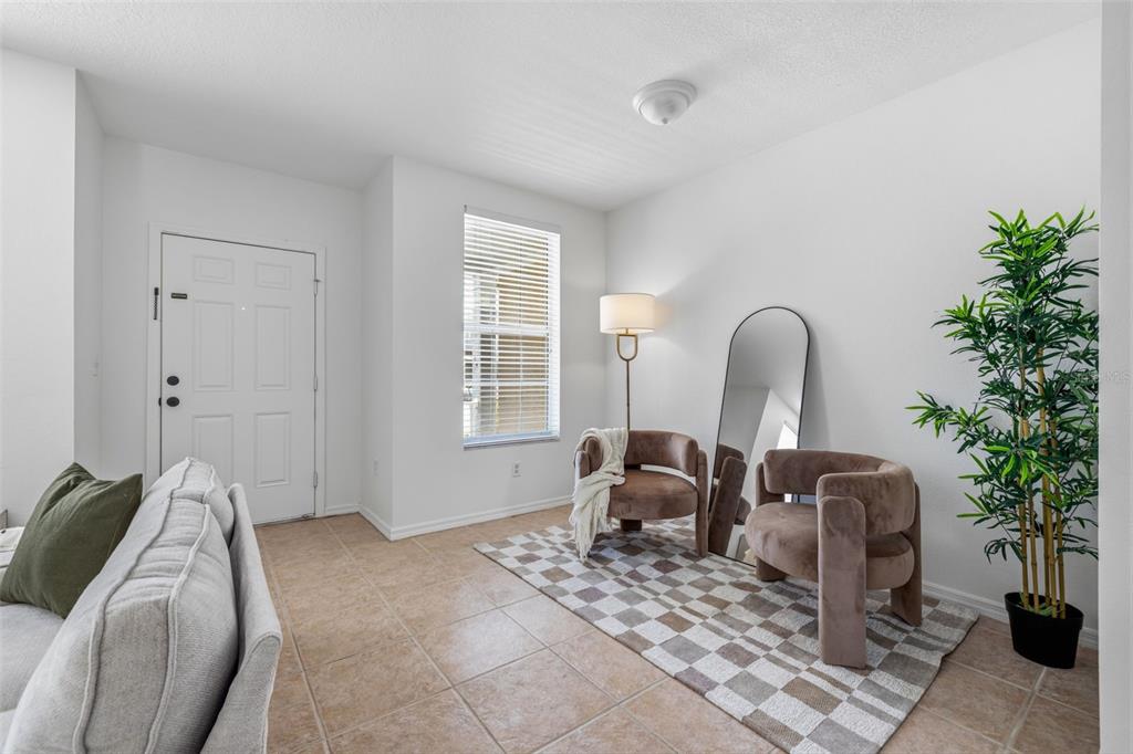 A living area features tile flooring, two armchairs, a floor mirror, and a potted plant — 515 SWEET HOLLOW PLACE, BRANDON, FL