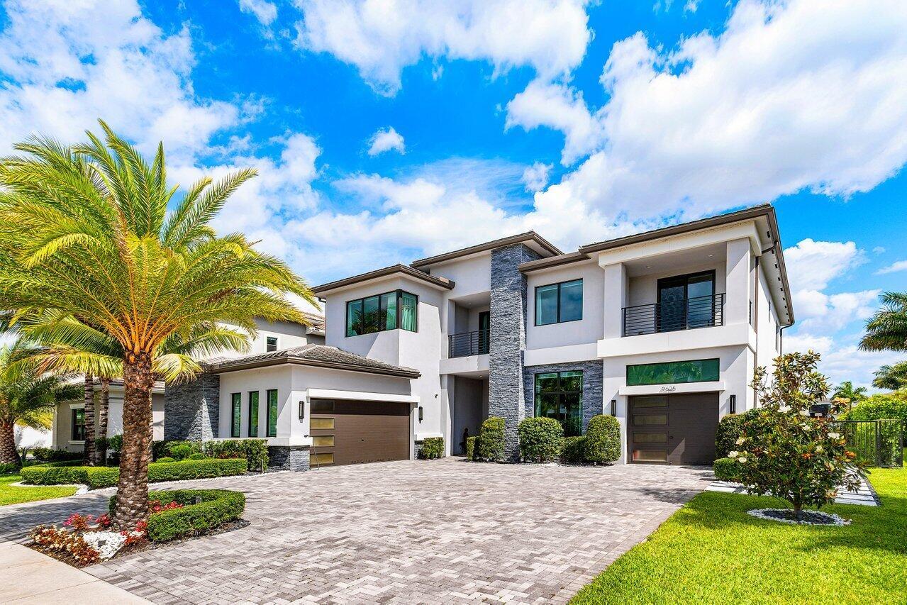 A two-story modern house with a stone facade, gray stucco, and a paved driveway — 9625 Vescovato Way, Boca Raton FL 33496, BOCA RATON, FL