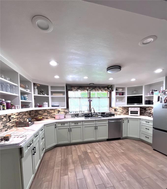 A gray single-story house with a stone facade, black shutters, and a large attached carport — 209 ALTA VISTA STREET, DEBARY, FL