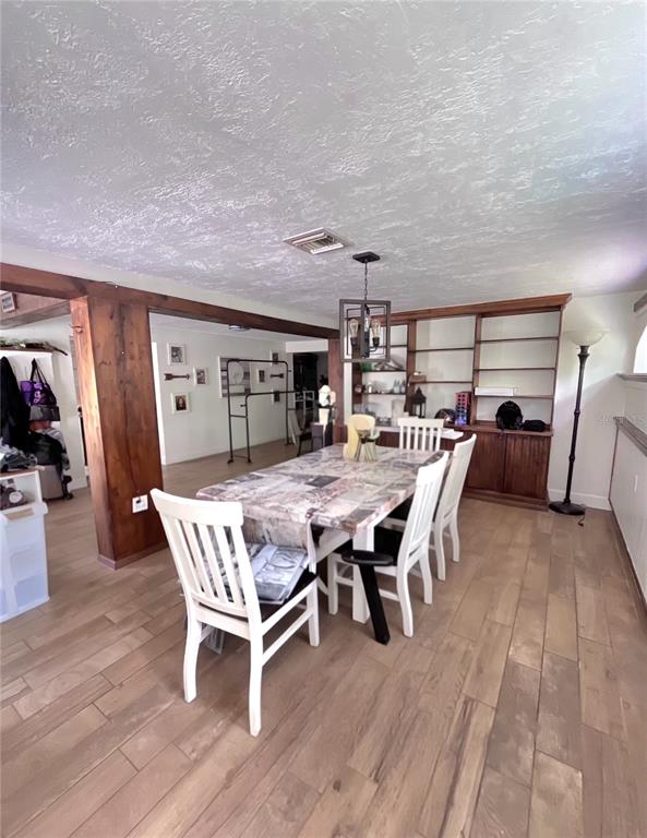 A gray single-story house with a large concrete driveway and a covered front porch — 209 ALTA VISTA STREET, DEBARY, FL