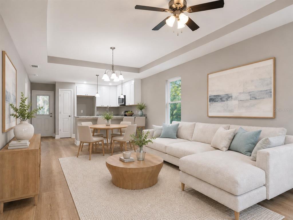 A living room with a sectional sofa, round coffee table, and adjacent dining area — 8507 SE 70TH AVENUE, TRENTON, FL