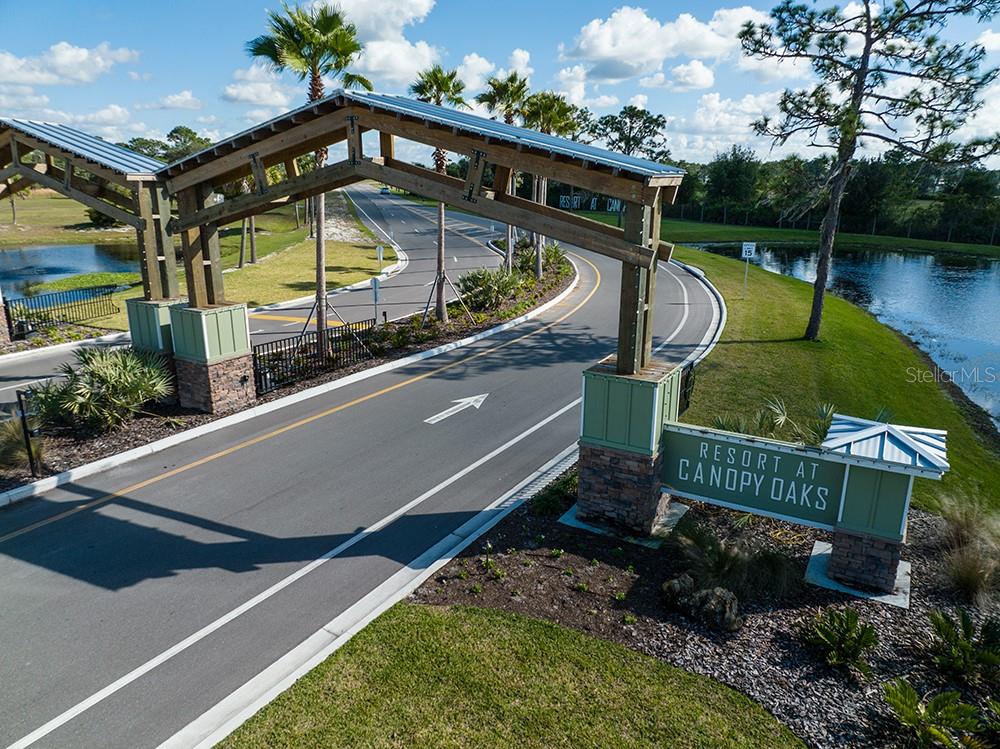 An aerial view of the entrance gate and road leading into the Resort at Canopy Oaks — 103 HIGHWAY 630 E, LAKE WALES, FL
