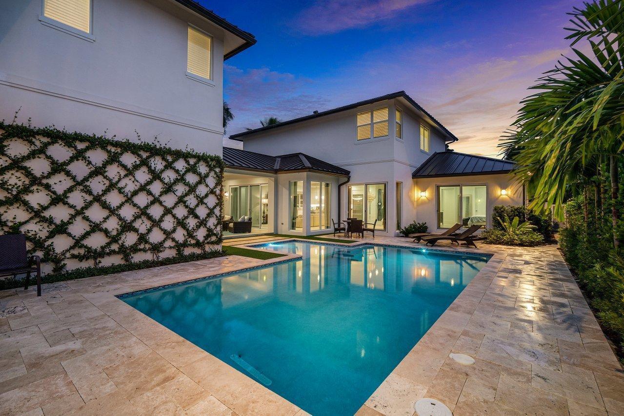 A modern two-story house features a swimming pool, stone patio, and a vine-covered wall — 217 Gulfstream Boulevard, Boynton Beach FL 33435, BOYNTON BEACH, FL