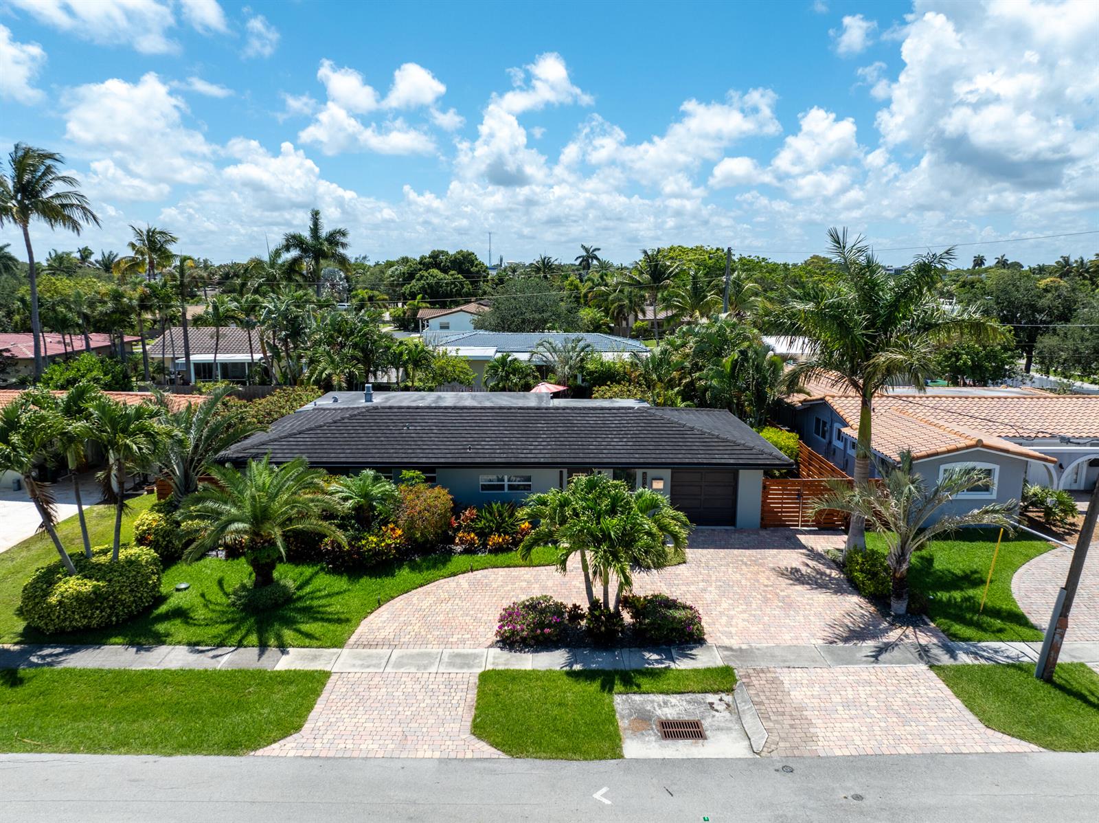 An aerial view shows a single-story house with a dark roof and a paved driveway — 5041 NE 24th Avenue, Lighthouse Point FL 33064, LIGHTHOUSE POINT, FL