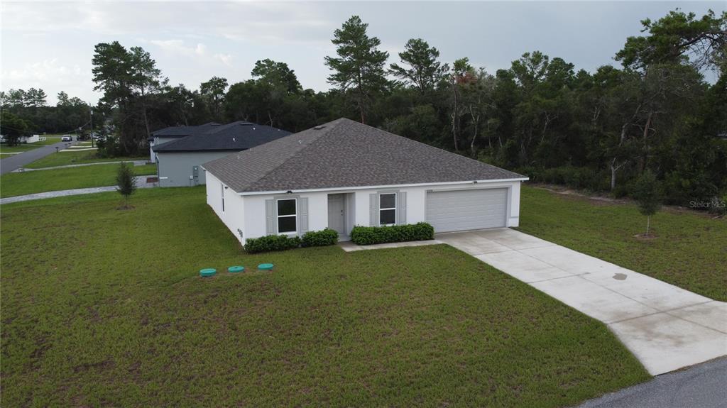 An aerial view of a single-story white house with a gray roof and garage — 17294 SW 39TH CIRCLE, OCALA, FL