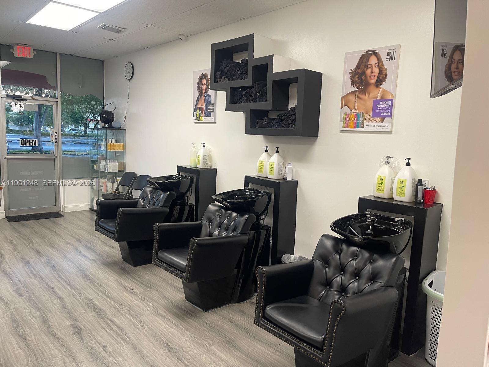 A hair salon features three black shampoo stations with tufted chairs against a white wall — 627 S State Road 7, Hollywood FL 33023, HOLLYWOOD, FL