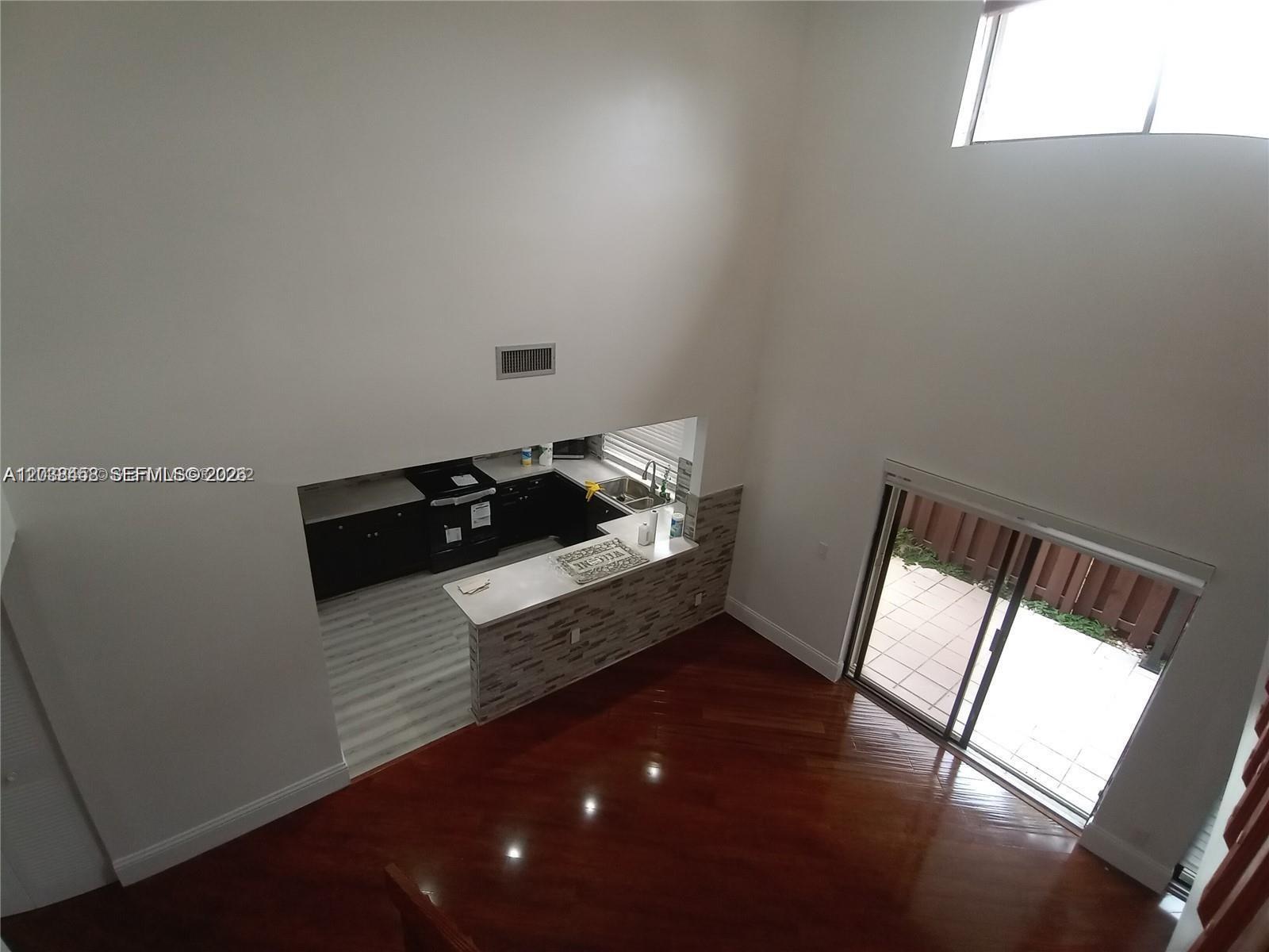 A high-angle view shows a kitchen with dark cabinets and a stone-tiled breakfast bar — 6533 NW 170th Ln, Hialeah FL 33015, HIALEAH, FL