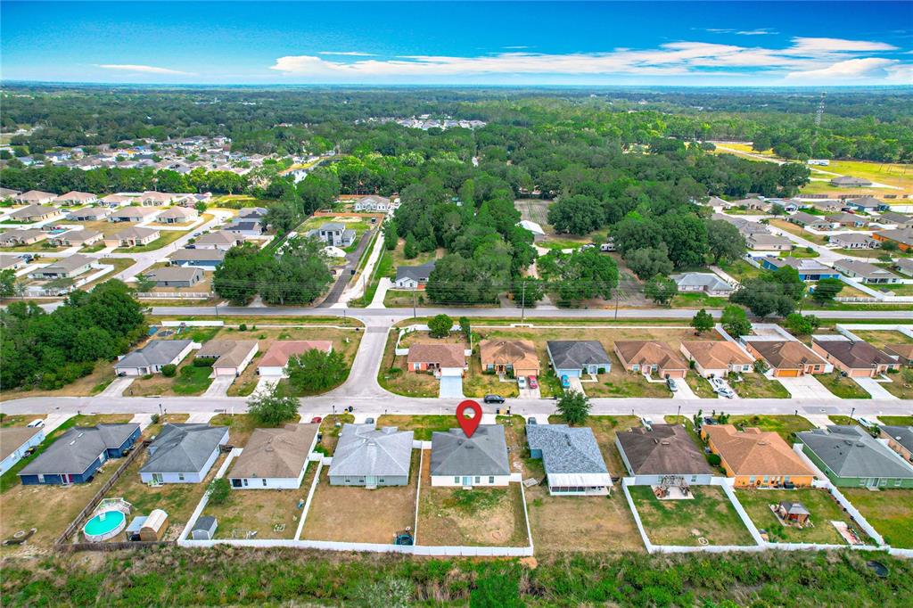 An aerial view shows a suburban neighborhood with a red pin marking a single-family house — 1639 SADDLEHORN DRIVE, LAKELAND, FL