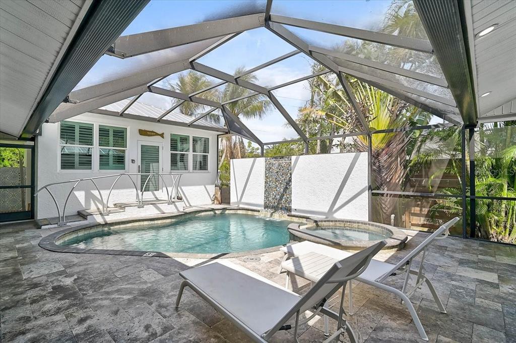 A single-story house with a white exterior, a metal roof, and a paved driveway — 3515 LA PALOMA AVENUE, SARASOTA, FL
