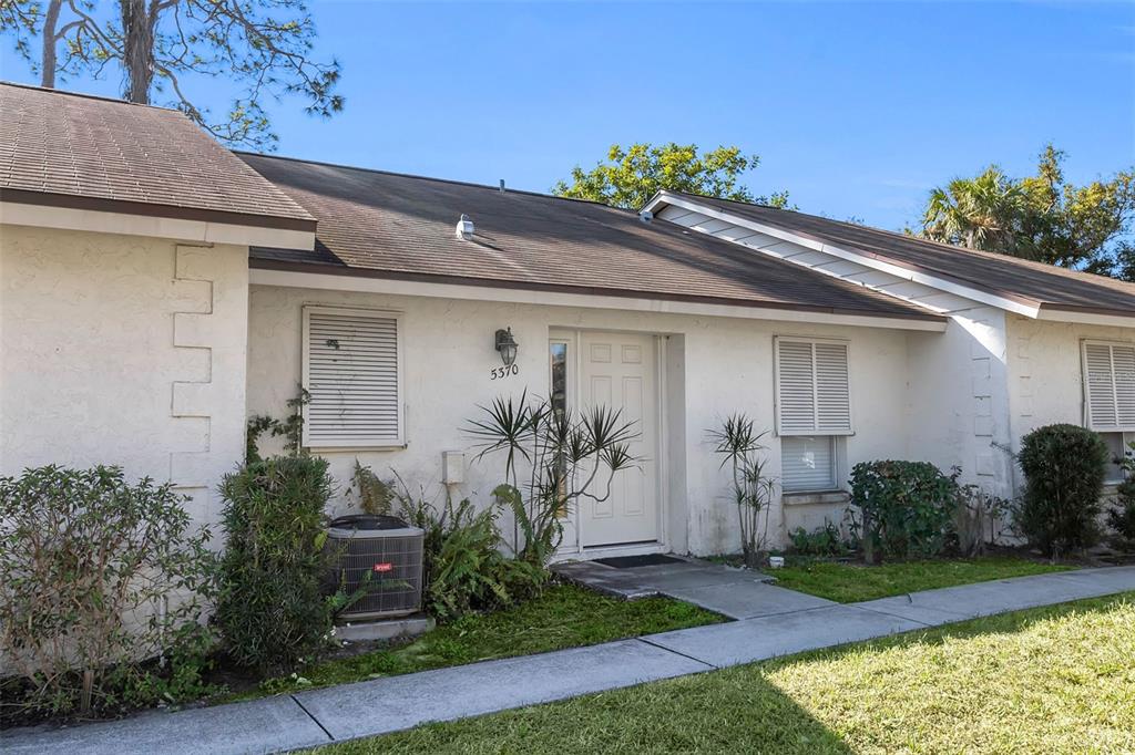 A single-story white house with a brown roof, shutters, and a front walkway — 5370 ROYAL PALM AVENUE UNIT 5370, SARASOTA, FL