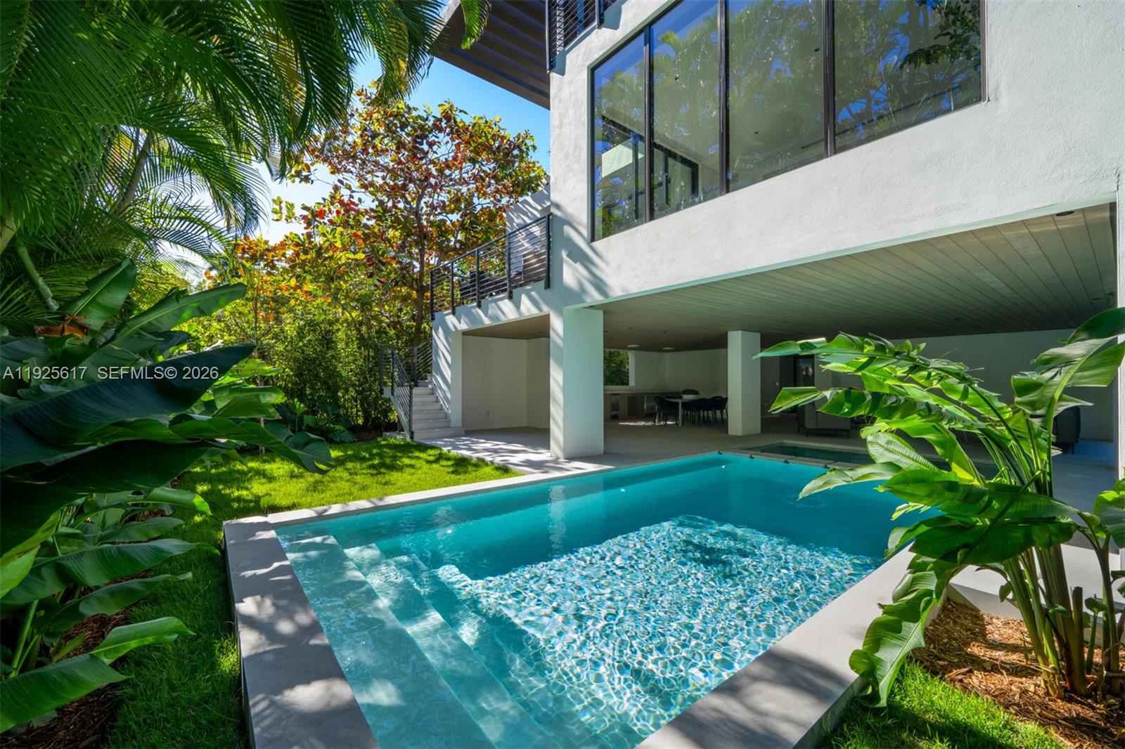 A modern house with a swimming pool and a covered patio area in the backyard — 3551 Crystal Ct, Miami FL 33133, MIAMI, FL