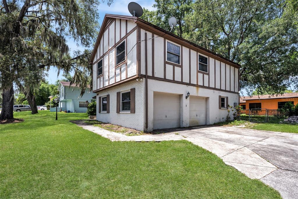 A two-story building with a white brick lower level and half-timbered upper exterior — 8020 TIERRA VERDE DRIVE, TAMPA, FL