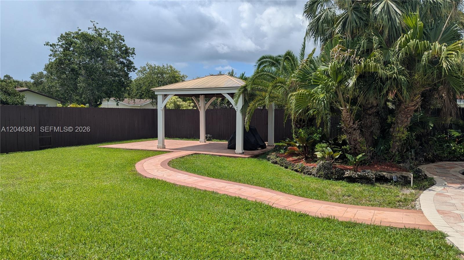 An aerial view shows a white house with a metal roof and a fenced yard — 10442 SW 114th St, Miami FL 33176, MIAMI, FL