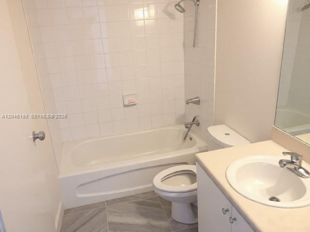 A bathroom features a white bathtub with a showerhead, a toilet, and a vanity sink — 5091 NW 7th St # 0, Miami FL 33126, MIAMI, FL
