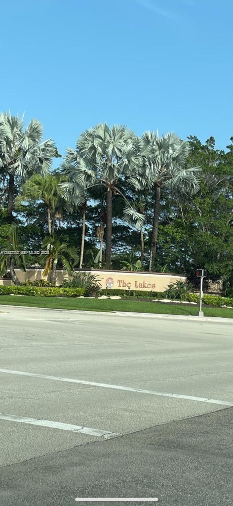A sign reading The Lakes stands behind a road with palm trees in the background — 558 Stonemont Dr # 558, Weston FL 33326, WESTON, FL