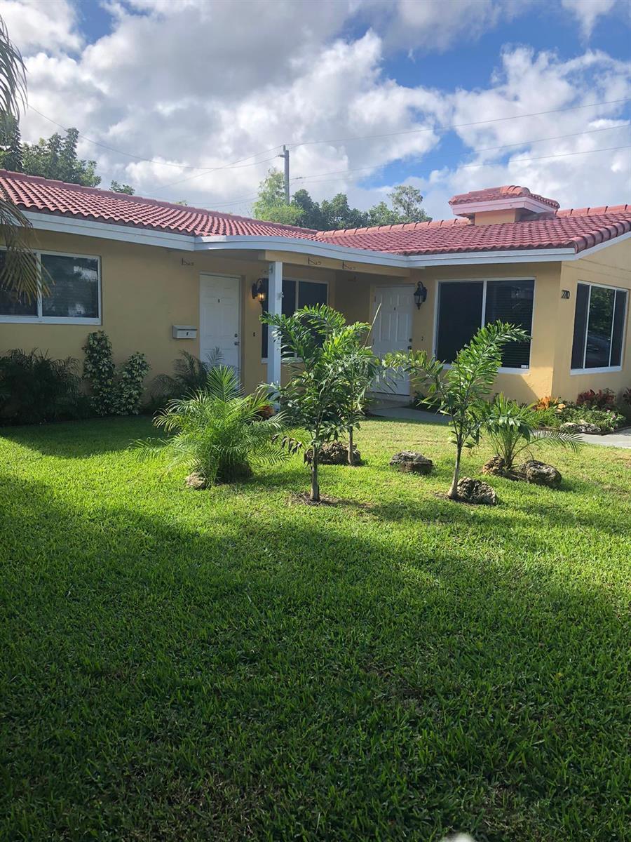 A single-story house with a red tile roof, tan stucco walls, and a front lawn — 2210 NE 36th Street, Lighthouse Point FL 33064, LIGHTHOUSE POINT, FL