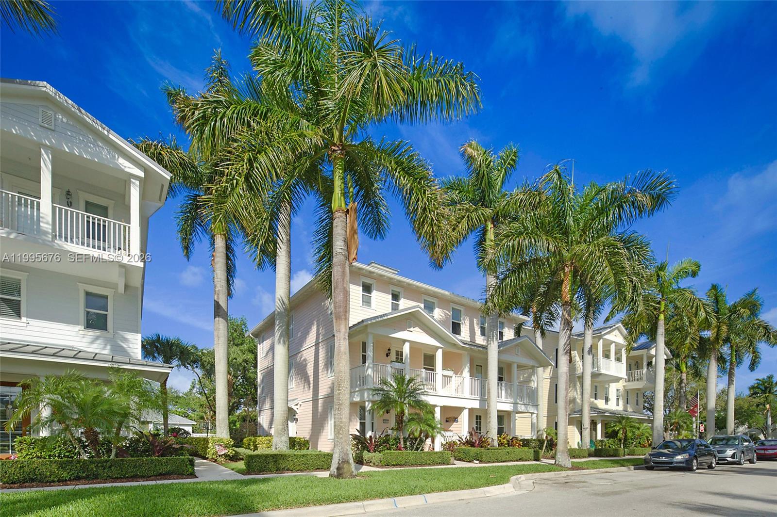 Exterior view of multi-story residential buildings with palm trees and a paved street — 3414 W Mallory Blvd, Jupiter FL 33458, JUPITER, FL