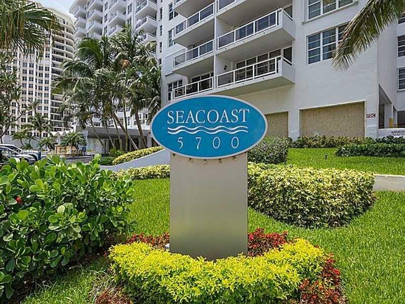 An oval sign for Seacoast 5700 stands in front of a multi-story white apartment building — 5700 Collins Ave # 8A, Miami Beach FL 33140, MIAMI BEACH, FL