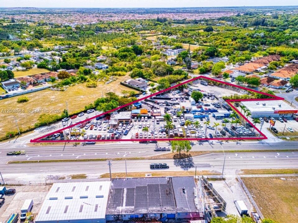 An aerial view shows a triangular commercial lot filled with parked cars and buildings — 22825 S Dixie Hwy, Miami FL 33170, MIAMI, FL