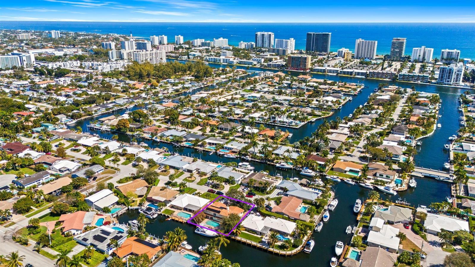 An aerial view of a waterfront house with a pool, highlighted by a purple outline — 1031 NE 27th Avenue, Pompano Beach FL 33062, POMPANO BEACH, FL