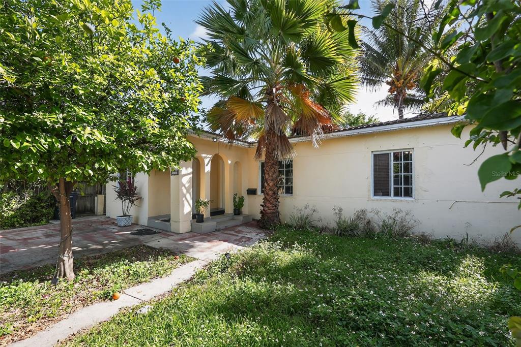A single-story house with a palm tree, a paved driveway, and a grassy front yard — 2131 BIARRITZ DRIVE, MIAMI BEACH, FL