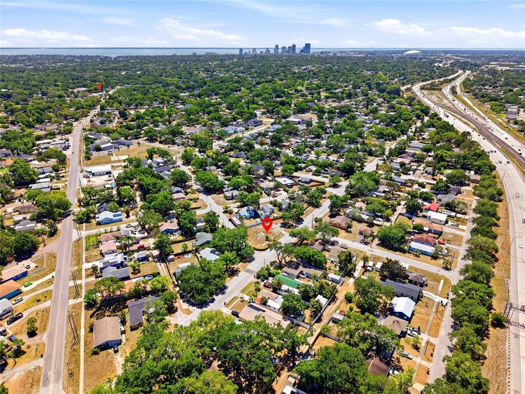An aerial view shows a residential neighborhood with a red pin marking a vacant lot — 4716 IRIS STREET N, ST PETERSBURG, FL