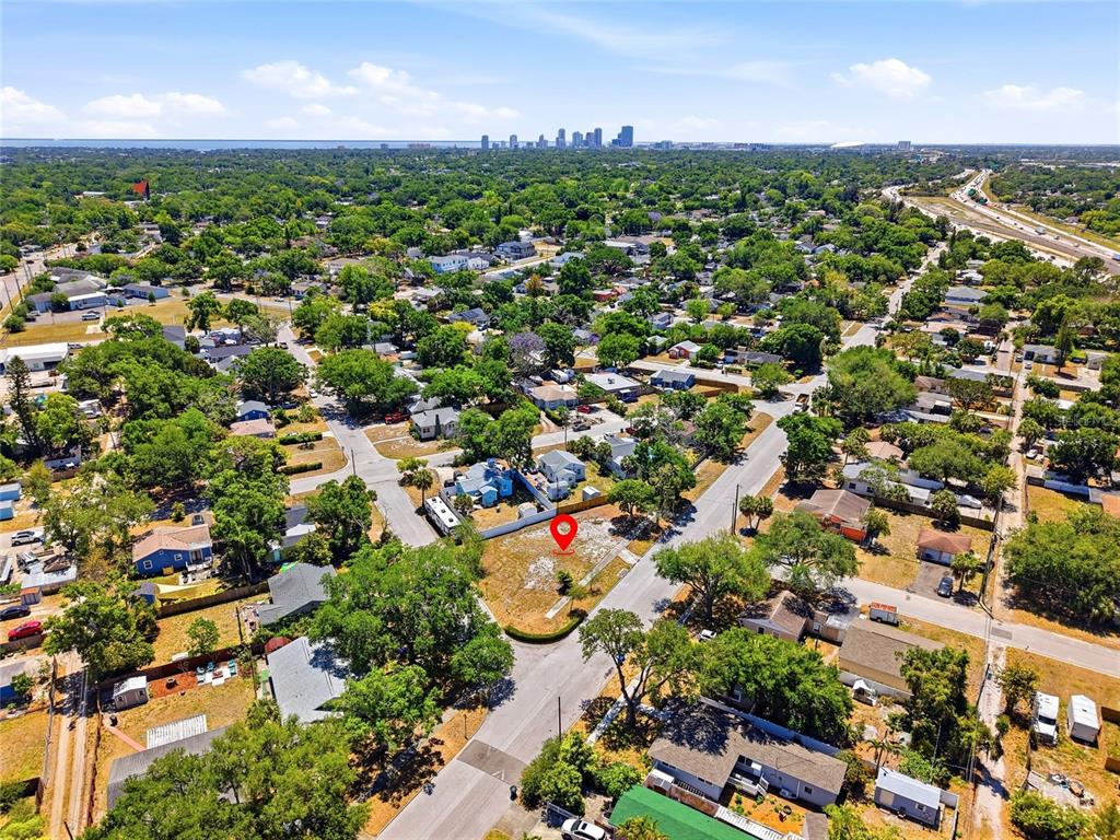 An aerial view shows a vacant lot marked with a red pin in a residential neighborhood — 4716 IRIS STREET N, ST PETERSBURG, FL