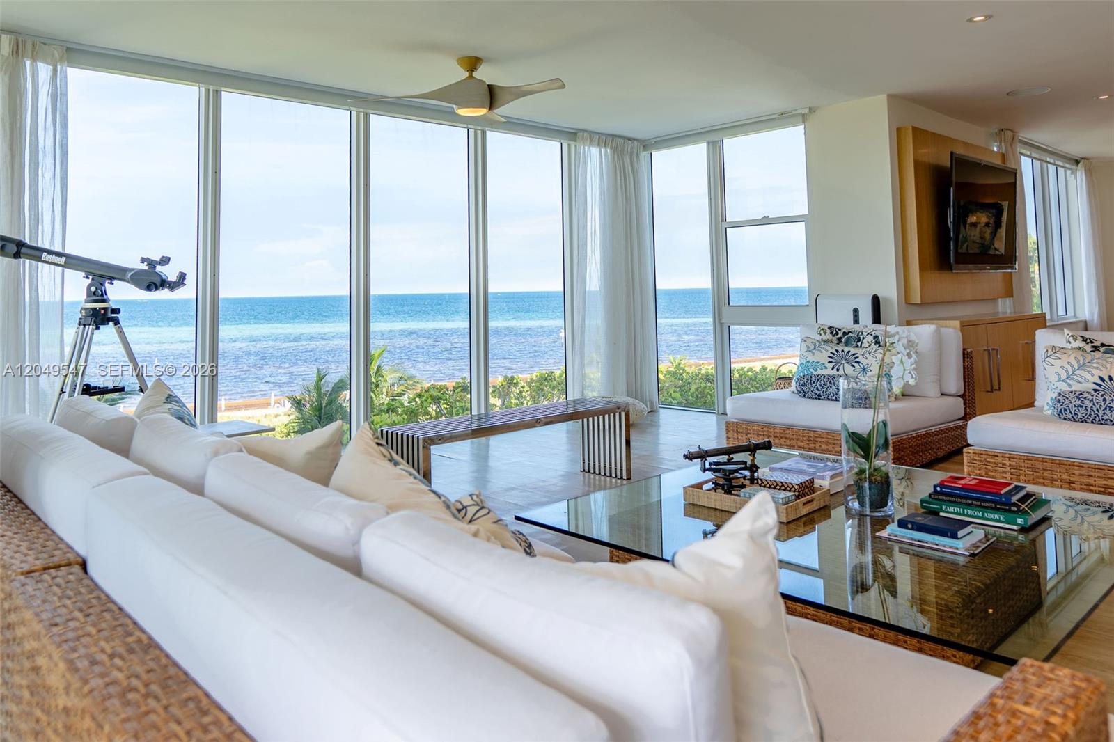 A living room features white sofas, a glass coffee table, and floor-to-ceiling ocean views — 200 Ocean Lane Dr # 501, Key Biscayne FL 33149, KEY BISCAYNE, FL