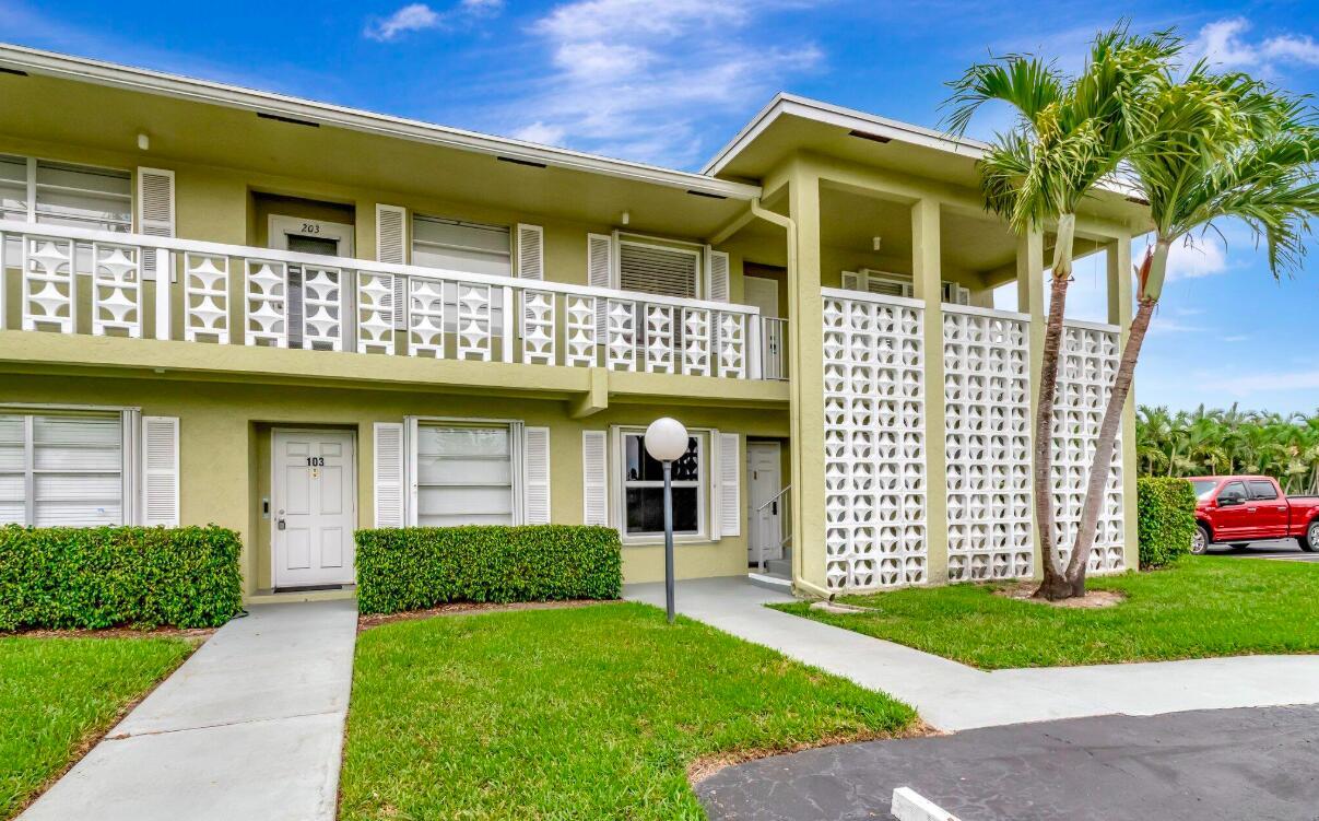 A two-story apartment building with a white balcony railing and a decorative concrete block screen — 1140 Mahogany Way # 204, Delray Beach FL 33445, DELRAY BEACH, FL