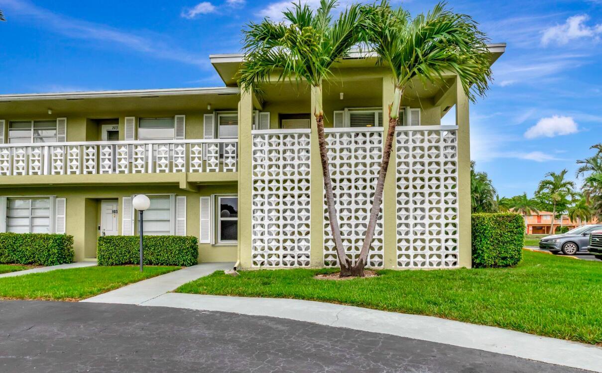 A two-story apartment building with a decorative concrete block screen and palm trees in front — 1140 Mahogany Way # 204, Delray Beach FL 33445, DELRAY BEACH, FL