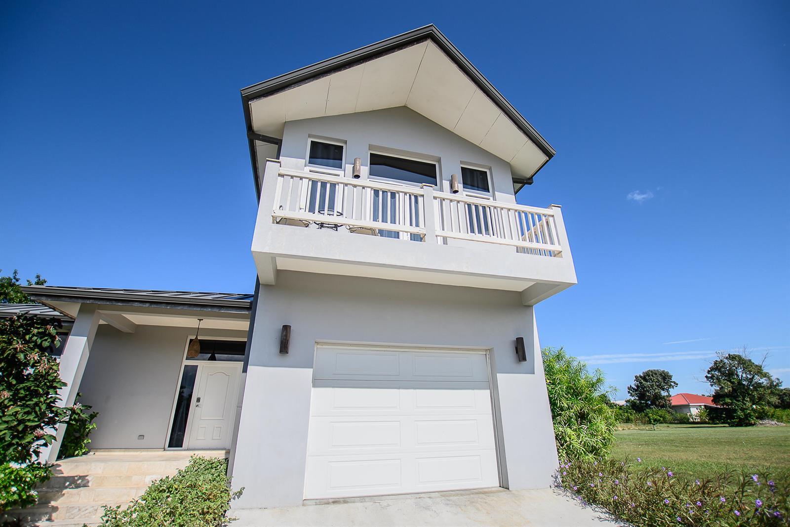 A two-story gray house features a white garage door and an upper-level balcony — Lot 37 Sittee River Road Lot 37, FL