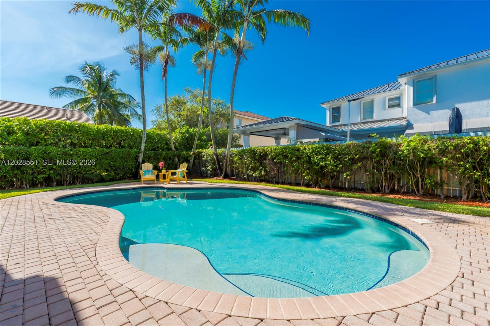 A backyard swimming pool with a brick paver deck, palm trees, and patio furniture — 19442 SW 39th St, Miramar FL 33029, MIRAMAR, FL