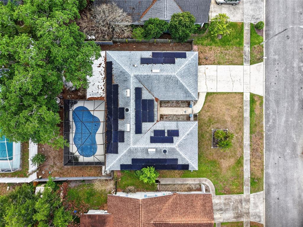 An aerial view shows a house with solar panels on the roof and a pool — 3217 LAKE ANDERSON AVENUE, ORLANDO, FL
