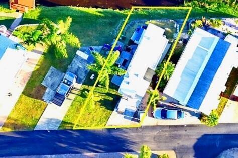 An aerial view shows a residential property with a house, driveway, and palm trees — 7950 W Hwy 78 Highway, Okeechobee FL 34974, OKEECHOBEE, FL