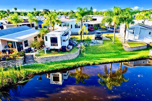 An aerial view shows a mobile home park with a pond in the foreground — 7950 W Hwy 78 Highway, Okeechobee FL 34974, OKEECHOBEE, FL