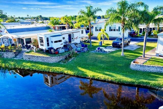 An aerial view shows a recreational vehicle parked next to a house by a canal — 7950 W Hwy 78 Highway, Okeechobee FL 34974, OKEECHOBEE, FL