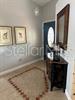 A foyer features a dark wood console table, a wall mirror, and two framed pictures — 2986 STILLWATER DRIVE, KISSIMMEE, FL